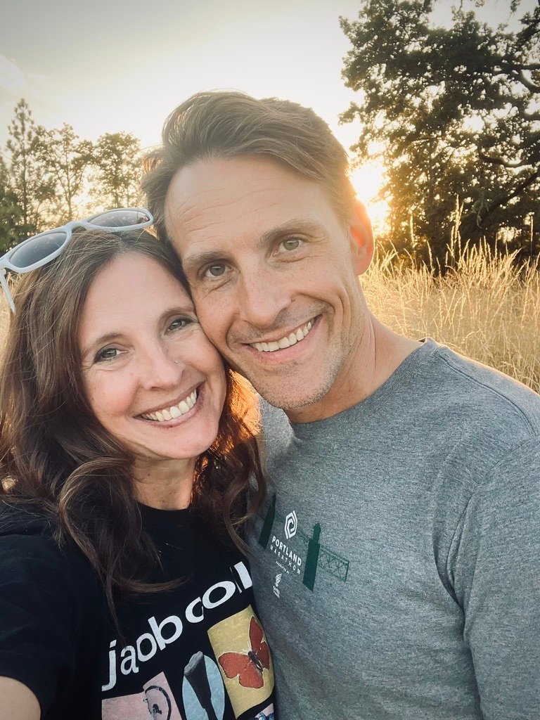 Jarod and Rachel smiling together in warm evening light
